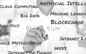 A black and white photo of a person writing "Blah, blah, blah" on a clear glass presentation board that contains a lot of technical jargon.